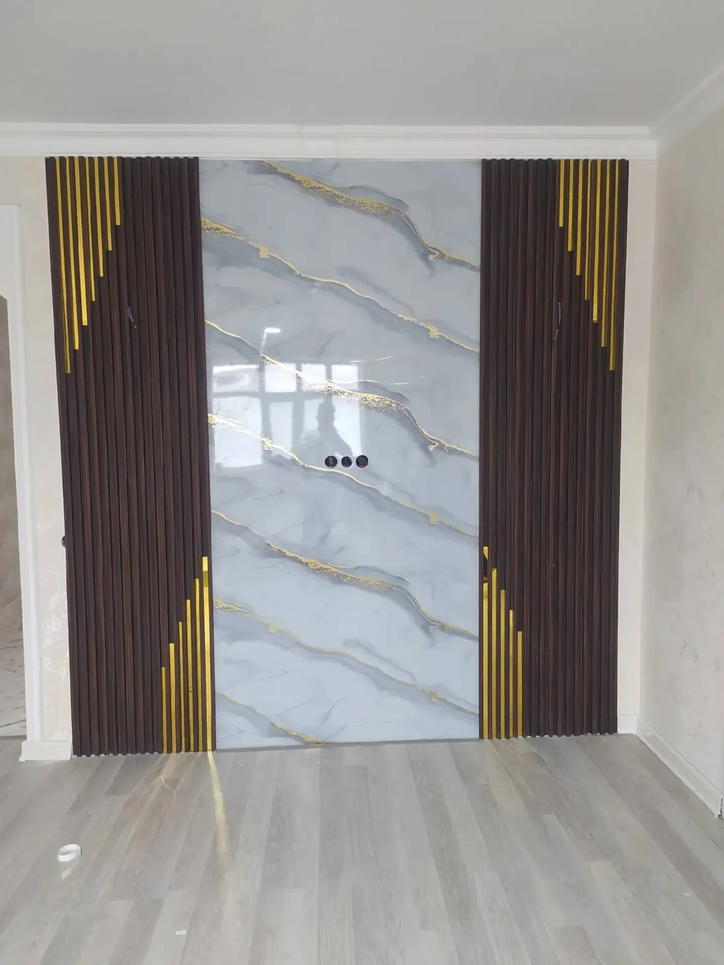 Worker Installing Large Format Marble Tile on Office Reception Wall